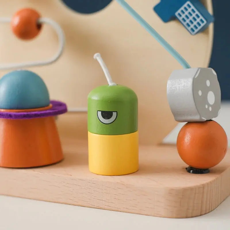 Introduce your Little One to the wonders of learning with our Montessori Wooden Beaded Planet Toy! This beautifully crafted wooden toy is designed to stimulate early learning, enhance hand-eye coordination, and improve finger grip.